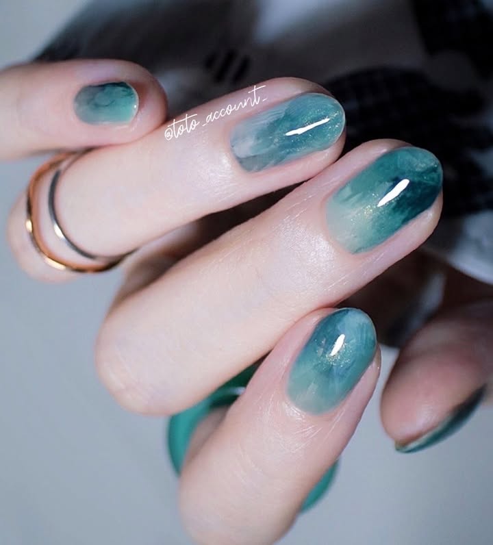 Aqua-tranquility-nails-in-soft-green-and-blue-tones-paired-with-stylish-rings-.jpg