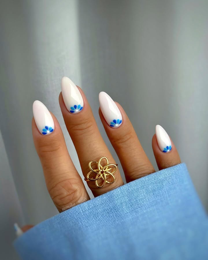 Arctic-petals-design-with-azure-blooms-near-the-cuticle-on-almond-nails