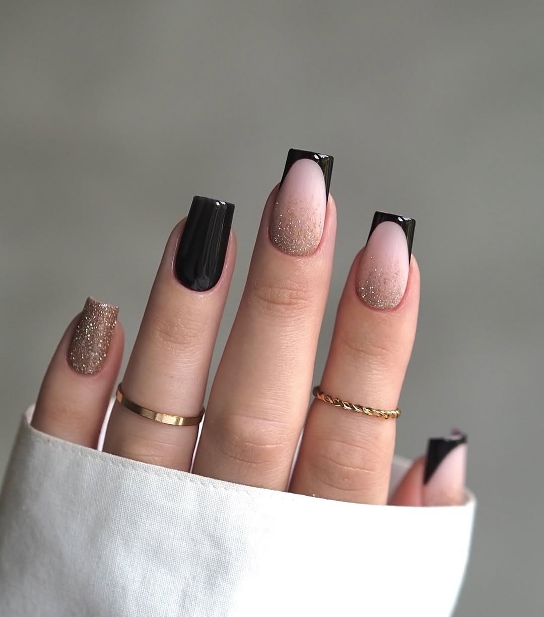 Black-French-nail-design-with-a-soft-pink-base-and-black-glitter