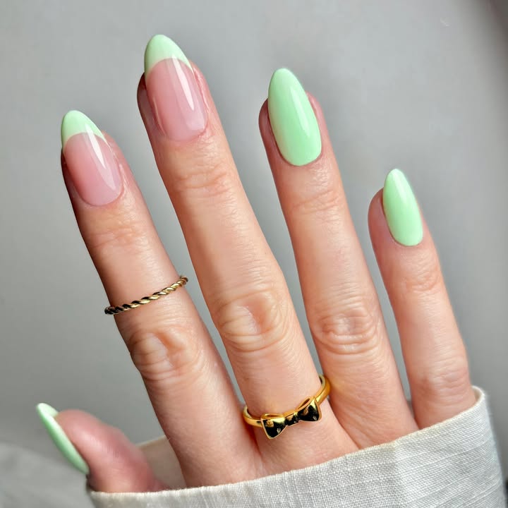 Close-up-of-hand-with-glossy-mint-spring-nails-paired-with-rings-and-a-white-outfit-for-a-fresh-chic-look.jpg