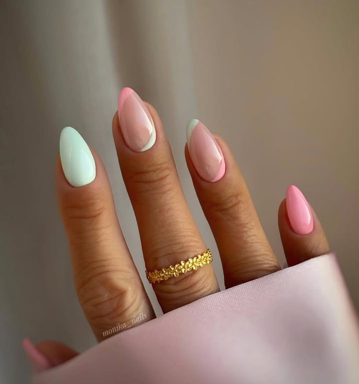 Close-up-of-hand-with-high-gloss-pastel-swirl-nails-in-pistachio-and-strawberry-shades.jpg