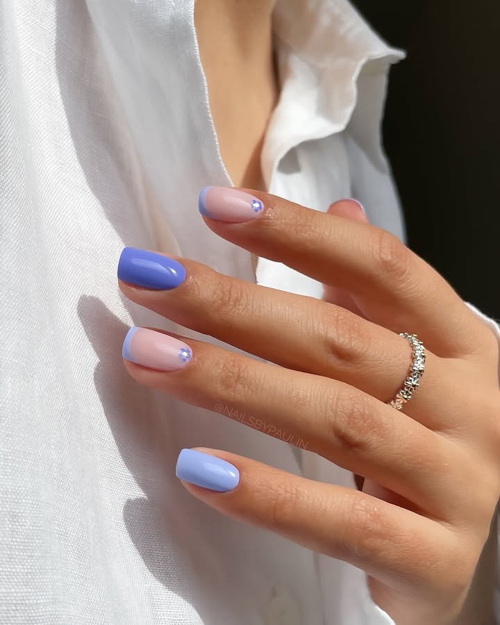 Close-up-of-hand-with-lavender-and-baby-blue-pastel-nails-on-a-translucent-nude-base-accented-with-delicate-crystals-paired-with-Ring.jpg