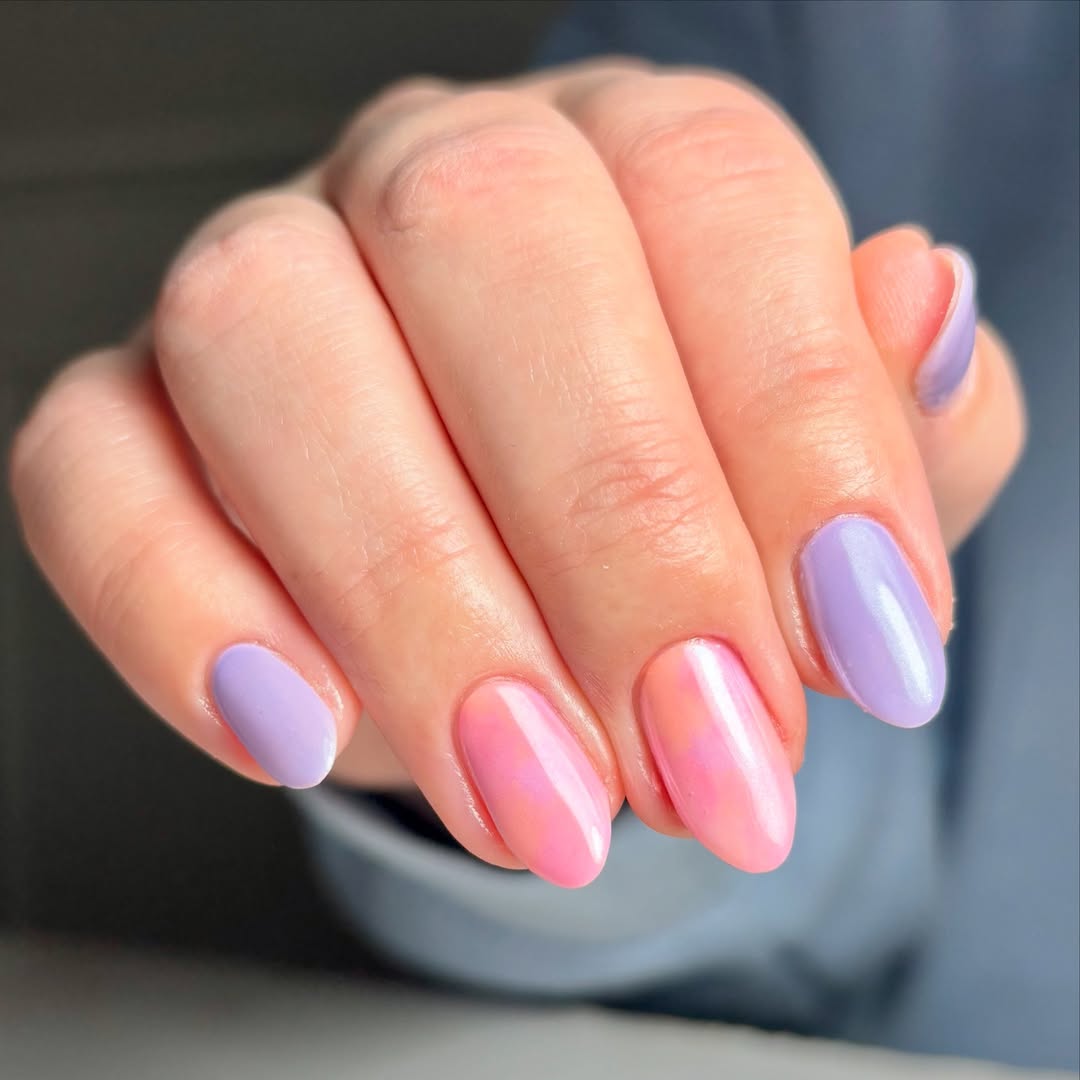 Close-up-of-hand-with-lavender-and-bubblegum-pink-satin-sheen-nails-in-a-soft-pastel-finish.jpg
