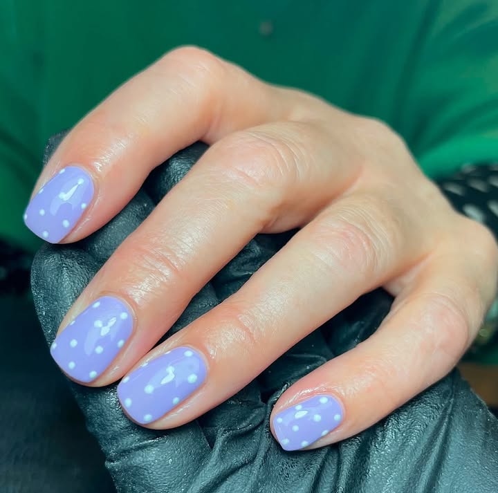 Close-up-of-hand-with-soft-lavender-nails-featuring-crisp-white-polka-dots.jpg