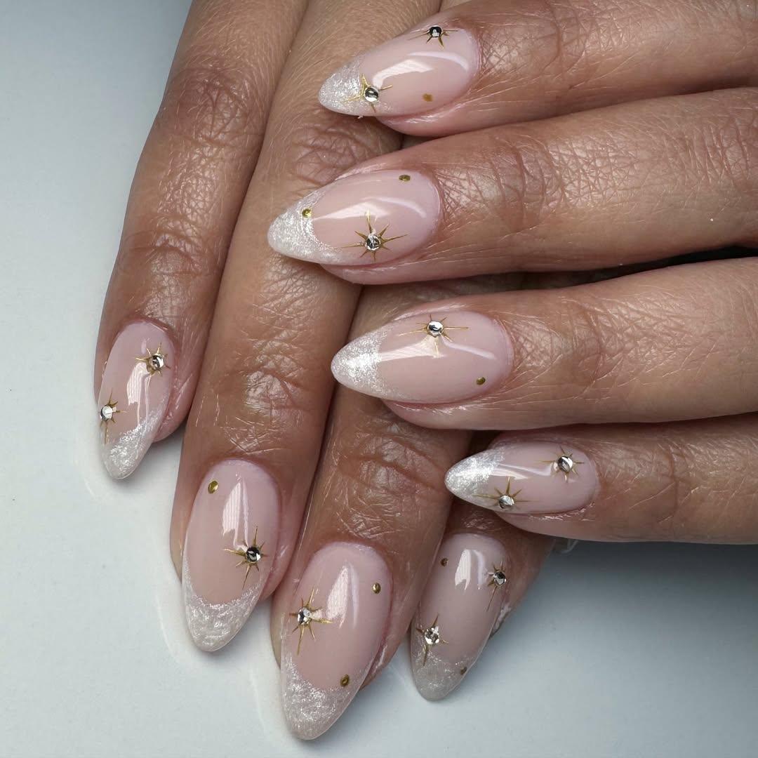 Frosted-white-french-tip-nails-with-gold-stars-and-rhinestones.