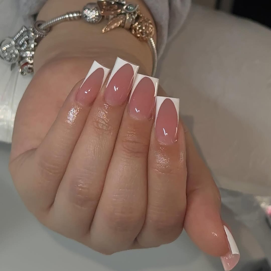 Geometric-white-French-tip-nails-on-nude-pink-base