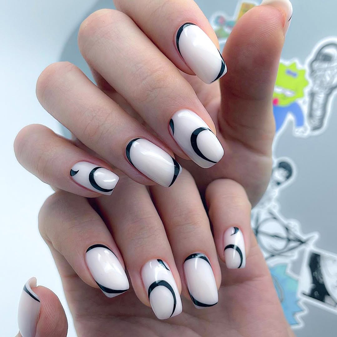 Glossy-white-nails-with-black-abstract-curved-lines.