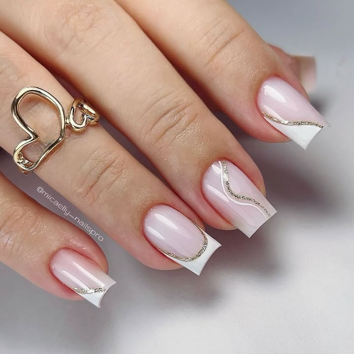 Golden-white-French-tip-nails-with-a-dreamy-pink-base-and-glossy-finish.