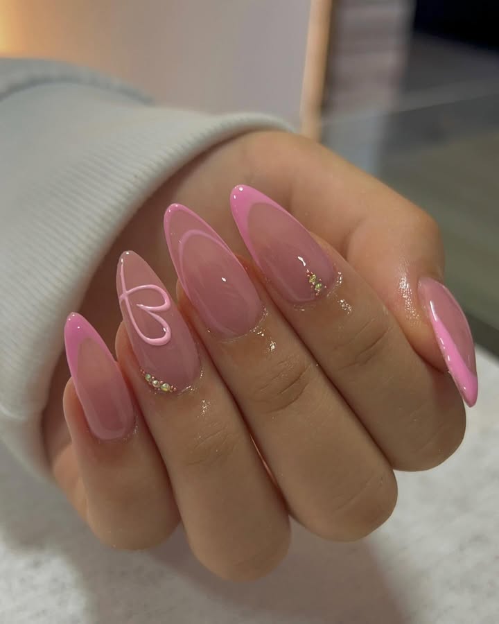 almond-Pink-french-tips-nails-with-glossy-finish-heart-design-and-glitter-accents-near-the-cuticles-and-a-soft-ombre-effect.jpg