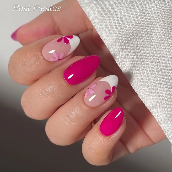 Hand- with-white-and-hot-pink-french-tip-nails-featuring-floral-accents-paired-with-a-white- shirt.jpg