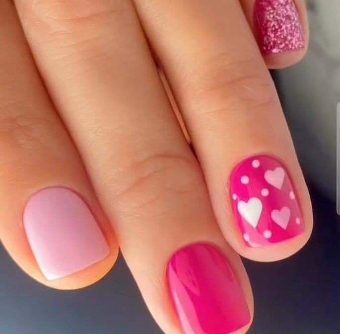 Hand-with-love-dots-and-hearts-nail-art-featuring-pastel-pink-bold-pink-white-hearts-and-polka-dot-accents.jpg