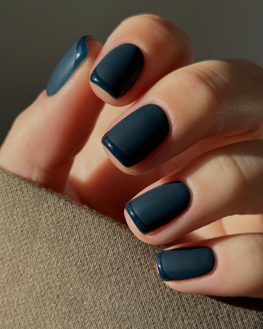 Hand-with-navy-blue-glossy-texture-nails- design-ideas
