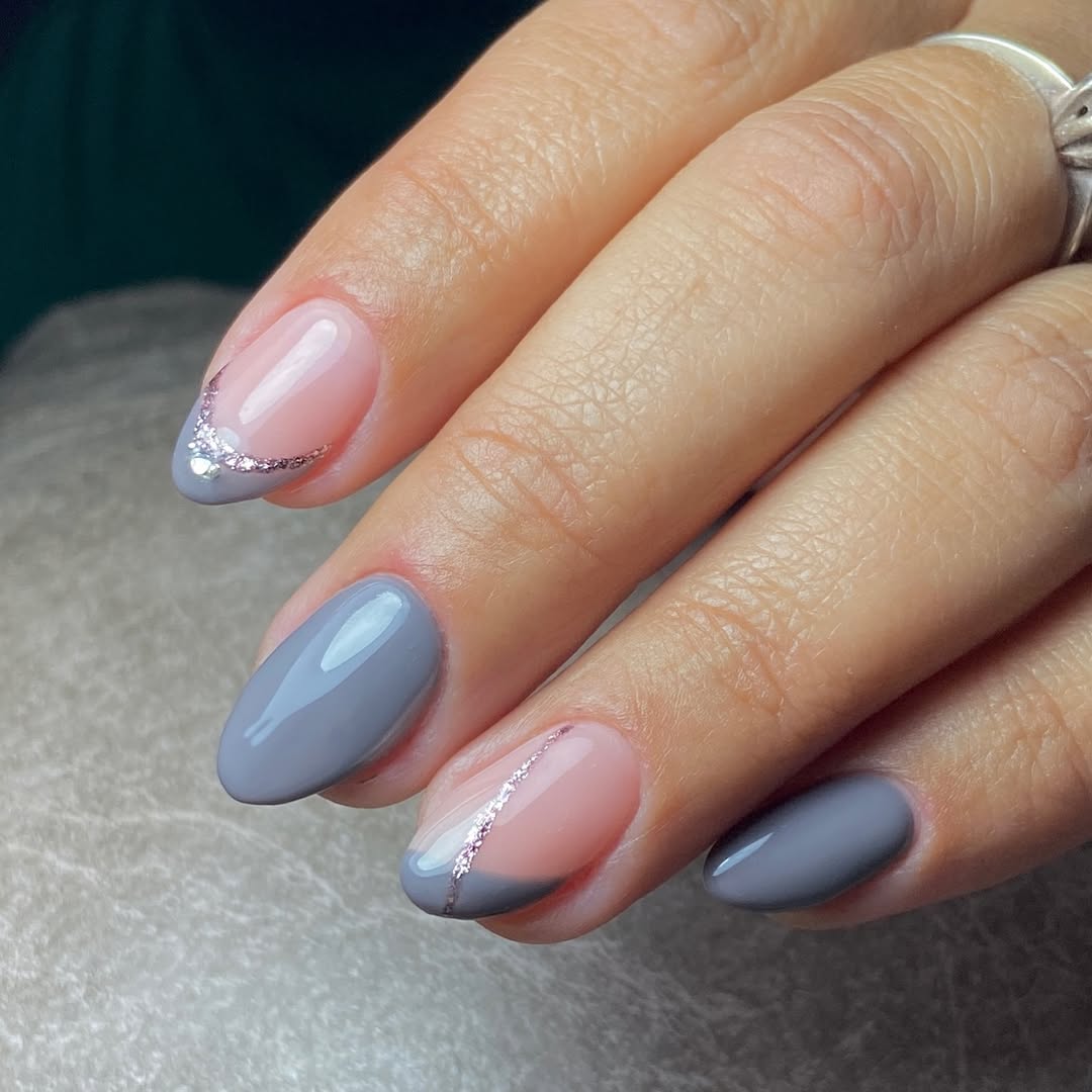 Hand-with-nude-pink-and-gray-mani-nail-design-with-subtle-glitter-accents.jpg