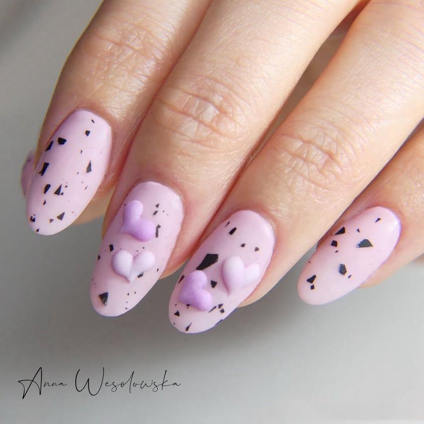 Hand-with-pink-speckled-nail-art-for-2025