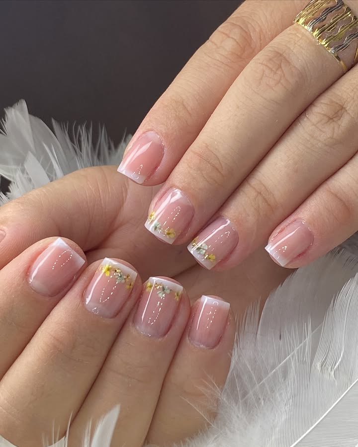 Hands-with-Golden-Blossom-tips-featuring-floral-accents-with-silver-beads-on-a-pink-base-and-crisp-white-tips.jpg
