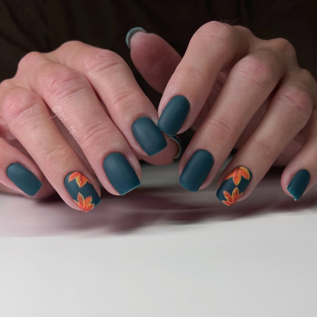 Hands-with-Matte-teal-nails-art-with-hand-painted-orange-flowers-for-a-distinctive-look.jpg
