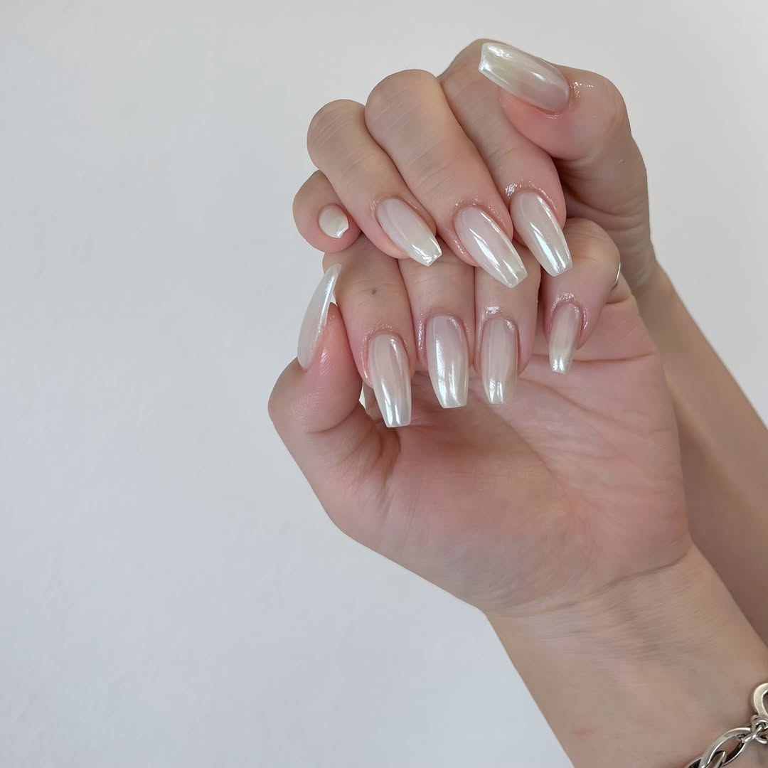 Hands-with-creamy-white-nail design-with-a-luminous-pearly-sheen.jpg