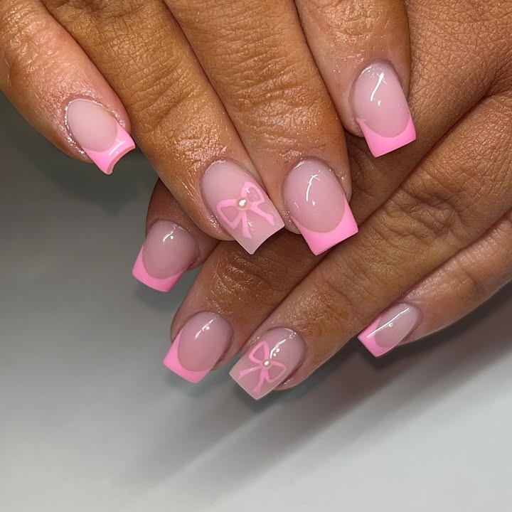 Hands-with-pastel-pink-French-tip-nails-with-bow-accents-and-a-clean-square-shape.jpg