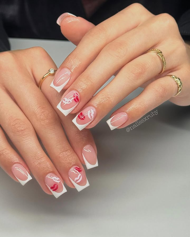 white-french-tip-nails-accented-by-dazzling-red-and-white-swirls.