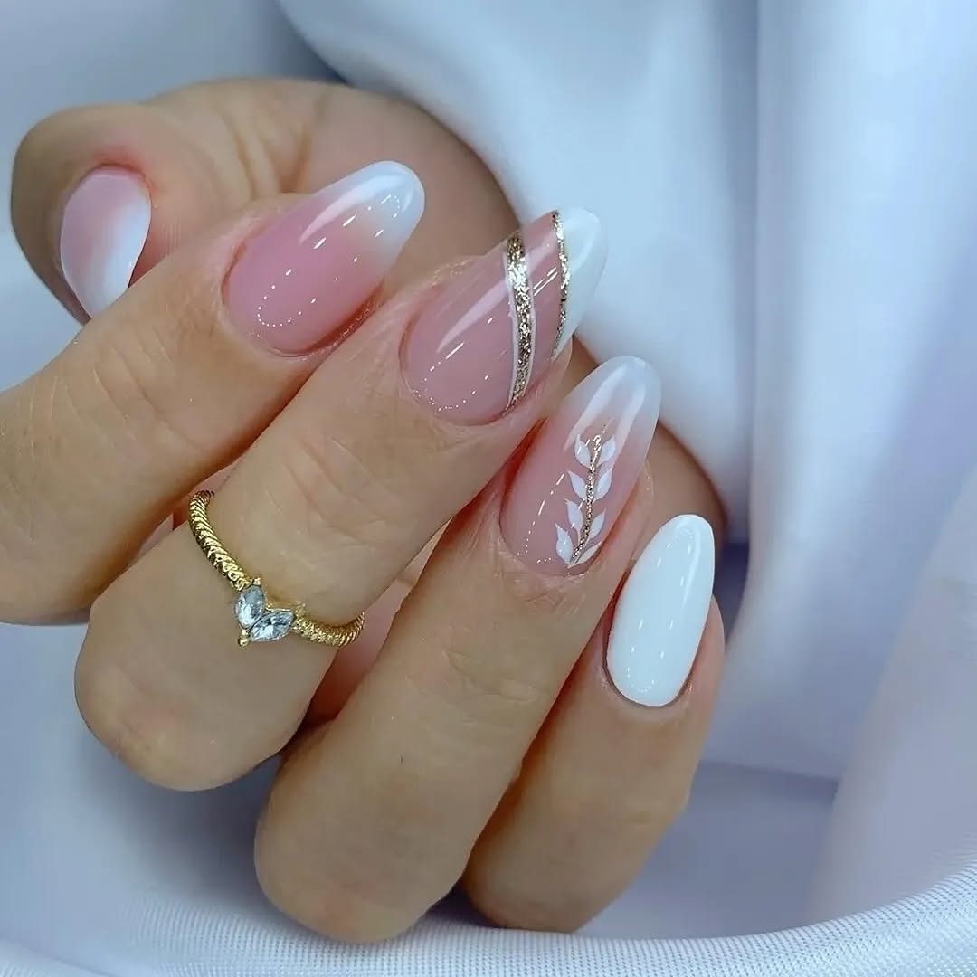 Soft-ombre-on-crisp-white-french-tip-nails-and-golden-accents.