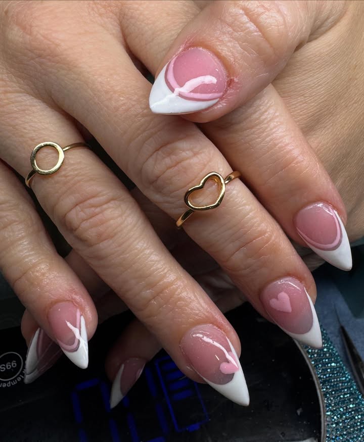 White-French-tip-nails-with-swirl-design-and-tiny-hearts.