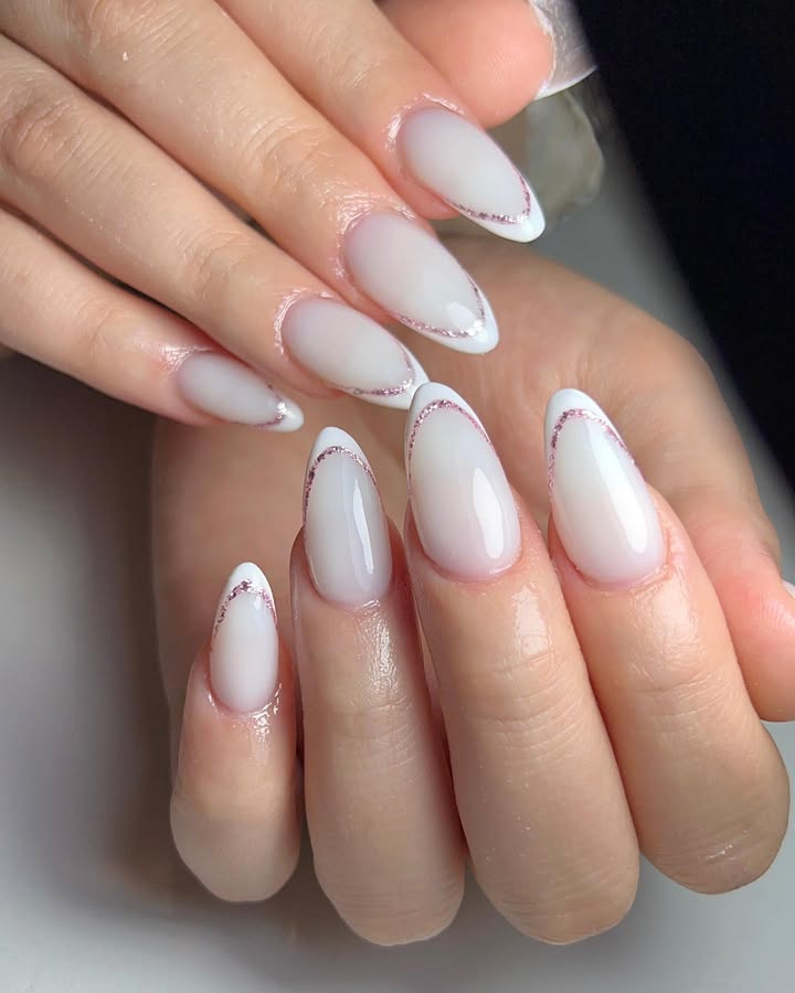 Almond-shaped-milky-white-nails-with-fine-glittery-curves.jpg