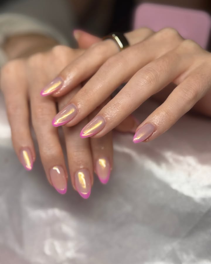 Close-up-of-frosted-peach-nails-with-electric-pink-tips-and-a-glassy-glaze-paired-with-Rings.jpg