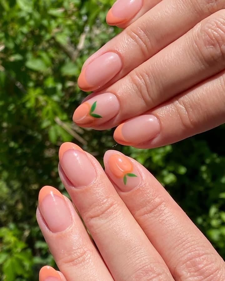 Close-up-of-nails-with-bright-peachy-orange-tips-offering-a-playful-summery-look.jpg