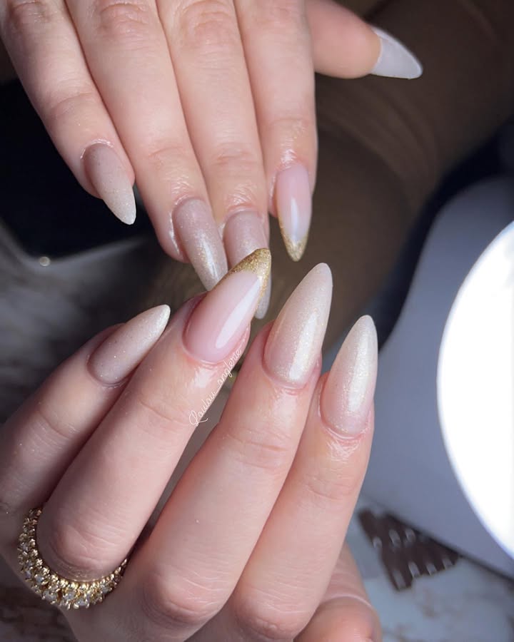 Creamy-ivory-nails-with-a-subtle-shine-and-elegant-gold-tipped-edges.jpg