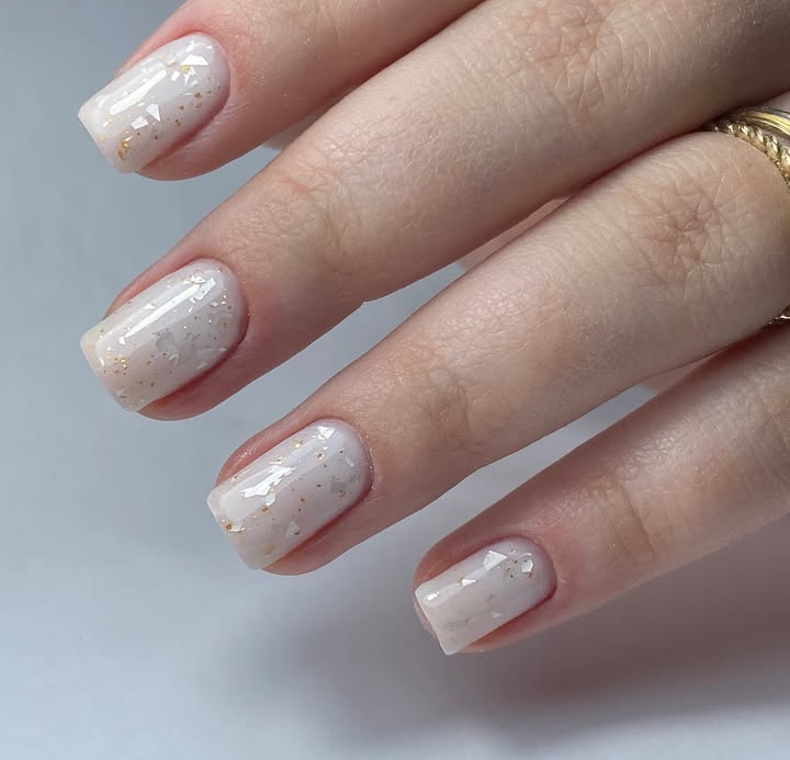 Glossy-milky-white-nails-with-shimmer-and-a-soft-golden-glow.jpg
