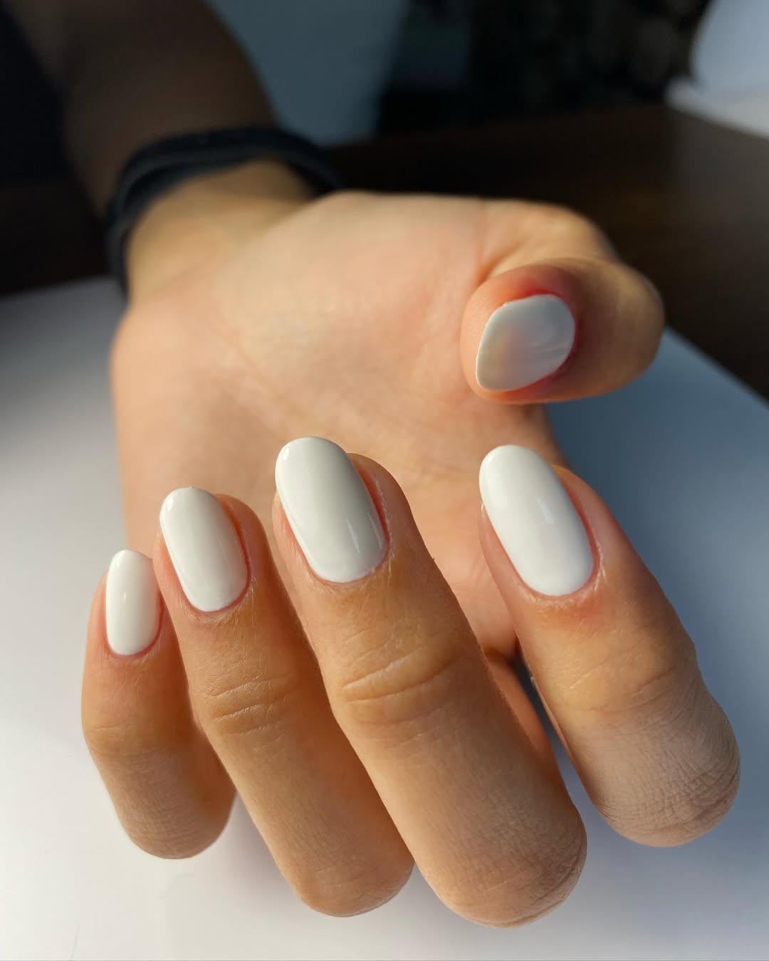 Glossy-oval-shaped-milky-white-nails-with-a-polished-porcelain-finish.jpg