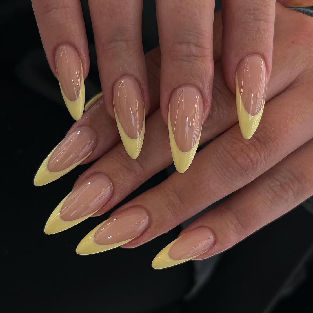 Lemon-French-stiletto-May-nails-with-yellow-tips-and-a-glossy-nude-base.jpg