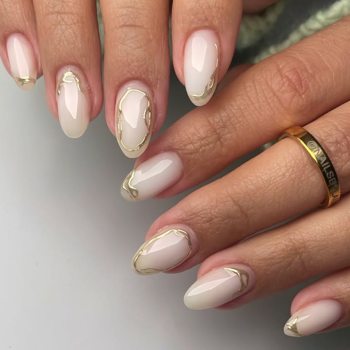 Milky-white-nails-accented-with-brushed-gold-edges.jpg