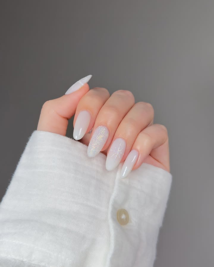 Milky-white-nails-with-soft-sparkle-and-delicate-details.jpg