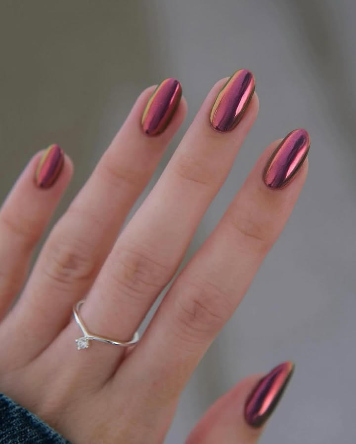 Molten-rose-chrome-nails-glowing-with-a-fiery-pink-metallic-finish-paired-with-ring.jpg