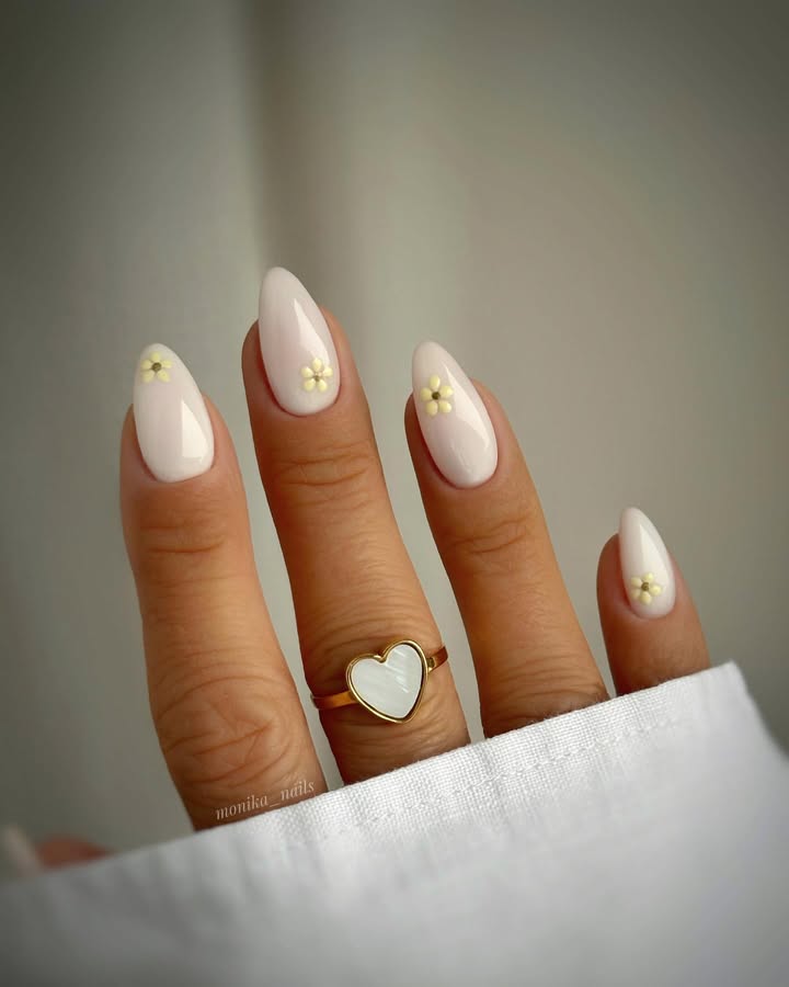 Nude-milky-white-nails-with-delicate-daisy-floral-accents.jpg