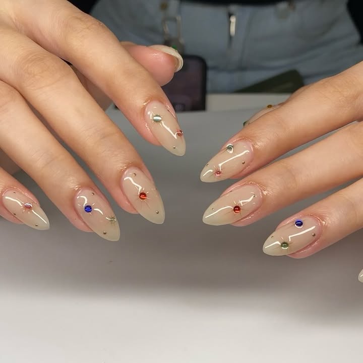 Pearl-white-nails-with-multicolor-crystals-and-chrome-squiggles.jpg