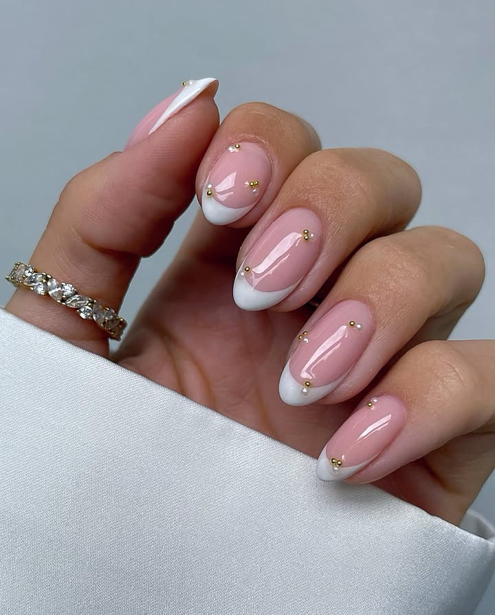 Sheer-blush-base-with-white-French-tips-and-gold-beads-perfect-for-May-nail-designs.__-1.jpg
