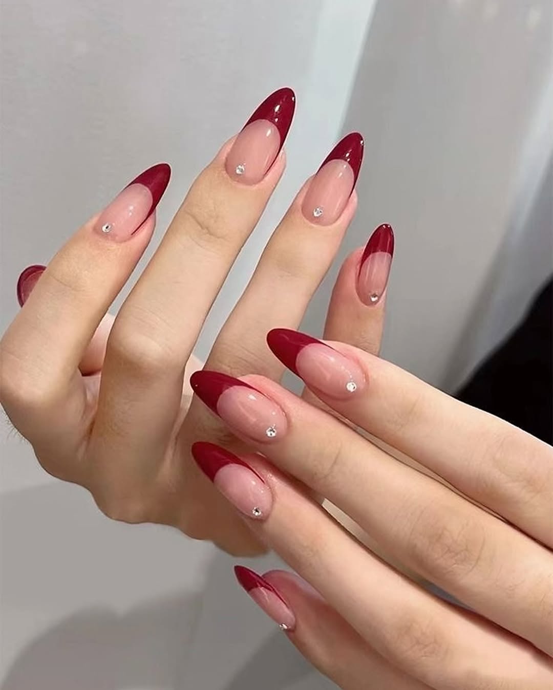 Cherry-red-stiletto-French-tip-nails-with-single-gem-accents.__.jpg
