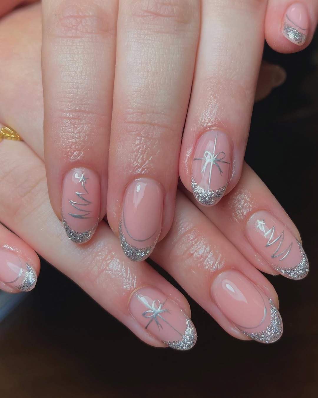 Tinsel-twist-French-tip-nails-with-beige-base-glitter-tips-and-tiny-bow-details._.jpg